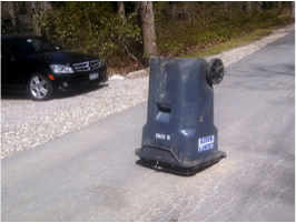 Trash can knocked over in the road