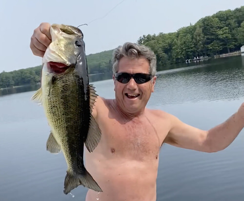 Rob Fusco landing a large mouth bass